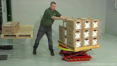 Man Removing Boxes Off Of Pallet Positioner